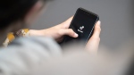 A teenager looks at a smartphone with the TikTok logo displayed. (Hannes P. Albert / dpa / picture alliance / Getty Images via CNN Newsource)