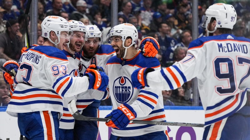 From left to right, Edmonton Oilers players Ryan Nugent-Hopkins, Zach Hyman, Leon Draisaitl, Evan Bouchard and Connor McDavid celebrate Nugent-Hopkins' goal  on May 20, 2024, during Game 7 of their NHL playoff series against the Vancouver Canucks. (Darryl Dyck/The Canadian Press)