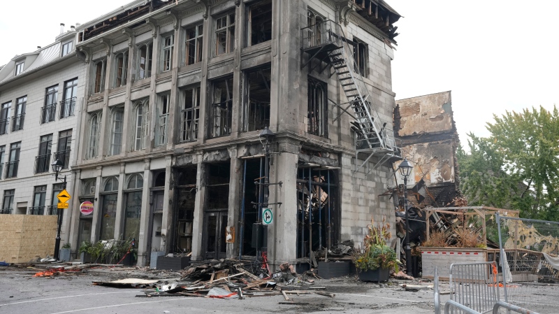 The burned out remains of a fire in which two people died last week are seen, in Old Montreal, Tuesday, Oct. 8, 2024. Quebec's chief coroner has announced a public inquest into the deadly blaze. (Ryan Remiorz, The Canadian Press)