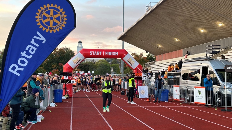 The crowd lines up at the finish line with the runners during the 32nd Harvest Valley Marathon on Sunday.