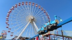 People wait in line to board rides at Gillian's Wonderland, the popular amusement park on the boardwalk in Ocean City, N.J., during its final day of operation before shutting down for good, Oct. 13, 2024. (AP Photo/Wayne Parry)