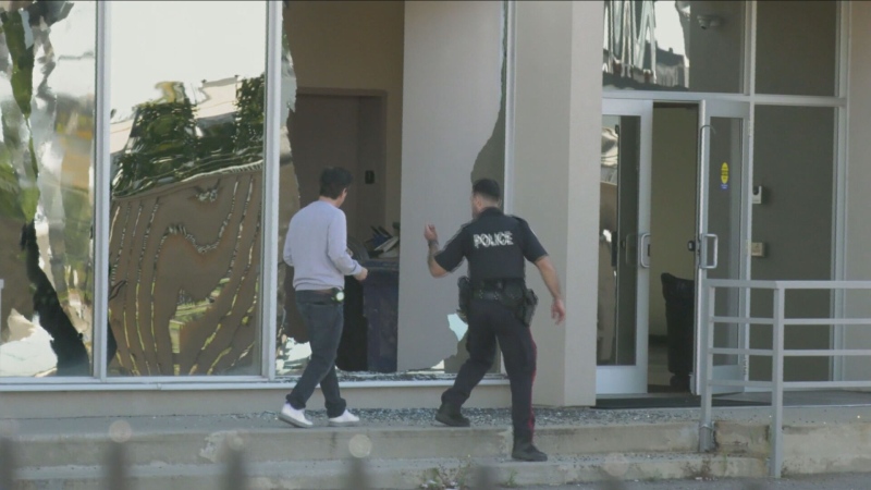 Police inspect a broken window at Bais Chaya Mushka elementary school Saturday October 12, 2024. The Jewish girls' school was shot at for the second time this year on Yom Kippur, the holiest day of the year for Jews.