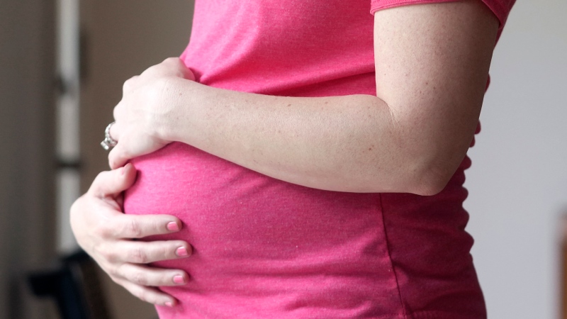 A pregnant woman stands for a portrait in Dallas, Thursday, May 18, 2023. THE CANADIAN PRESS/AP, LM Otero