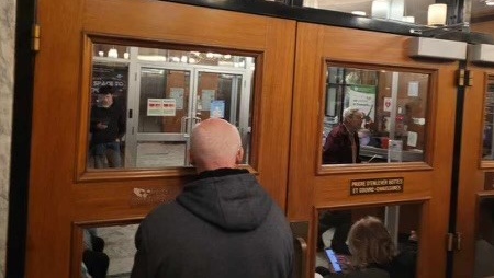 Voters lined up outside the English Montreal School Board offices on the final night to register for the upcoming school board election.  
