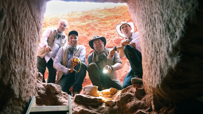 Josh Gates (from left), Dr. Pearce Paul Creasman, Dr. Fares Braizat and Fadi Balawi look into the newly discovered tomb at Petra. (Discovery’s Expedition Unknown via CNN Newsource)
