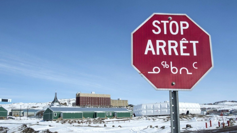 A stop sign in English, French and Inuktut syllabics is seen in Iqaluit, on April 25, 2015. One of the most widely spoken Indigenous languages in this country is now available through Google's translation service, the first time the tech giant has included a First Nations, Métis or Inuit language spoken in Canada on its platform. THE CANADIAN PRESS/Paul Chiasson