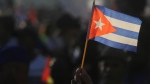 A person waves a Cuban flag during a gathering marking International Workers' Day at Anti-Imperialist Square in Havana, Cuba, Wednesday, May 1, 2024. (AP Photo / Ariel Ley)