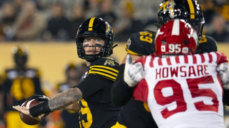 Hamilton Tiger-Cats quarterback Bo Levi Mitchell looks to make the pass against the Calgary Stampeders in Hamilton, Ont., on Oct. 18, 2024. THE CANADIAN PRESS/Peter Power