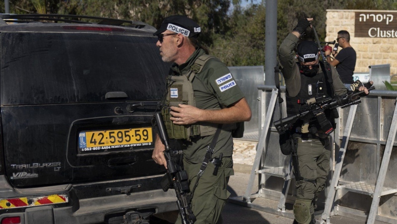 Israeli security forces secure a road near where Israel's government says a drone launched toward Israeli Prime Minister Benjamin Netanyahu's house in Caesarea, Israel Saturday, Oct. 19, 2024. (AP Photo/Ariel Schalit)