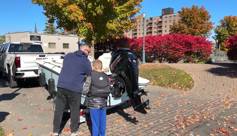 Brockville, Ont. resident Joe Norton putting his boat back in the water because of the nice weather. Oct. 20, 2024. (Jack Richardson/CTV News Ottawa).