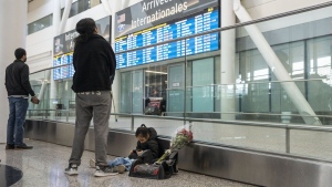 People wait for the arrival of a flight at Pearson Airport in Mississauga, Ont., Tuesday, March 14, 2023. THE CANADIAN PRESS/Chris Young