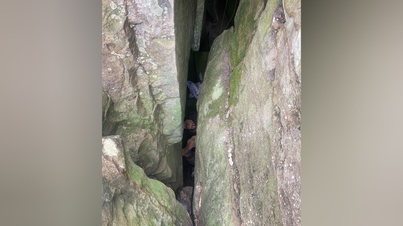 Only the feet of a woman trapped between two boulders can be seen in this image released by NSW Ambulance. (NSW Ambulance via CNN Newsource)
