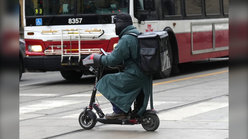 A food delivery courier rides an e-bike in Toronto on Wednesday, January 3, 2024. THE CANADIAN PRESS/Chris Young 