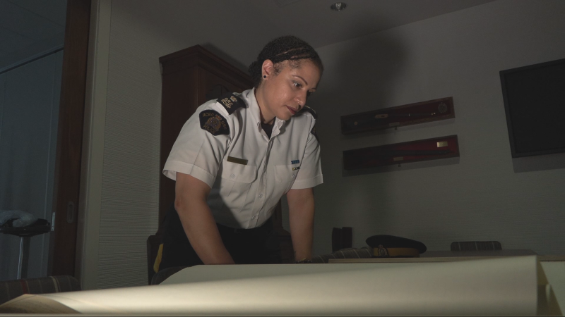 RCMP Insp. Veronica Fox looks at blueprints for the former RCMP headquarters in Vancouver on a site known as the Heather Lands. (CTV News)