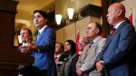 Prime Minister Justin Trudeau and Immigration, Refugees and Citizenship Minister Marc Miller are joined by fellow members of Parliament as they hold a press conference on Parliament Hill in Ottawa on Thursday, Oct. 24, 2024. THE CANADIAN PRESS/Sean Kilpatrick
