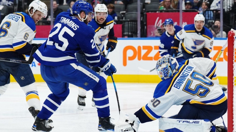 St. Louis Blues goaltender Jordan Binnington (50) stops Toronto Maple Leafs defenceman Conor Timmins (25) during second period NHL hockey action in Toronto on Thursday, October 24, 2024. THE CANADIAN PRESS/Nathan Denette