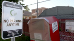 A clothing bin is seen on private property at a school in Toronto in this image taken video.