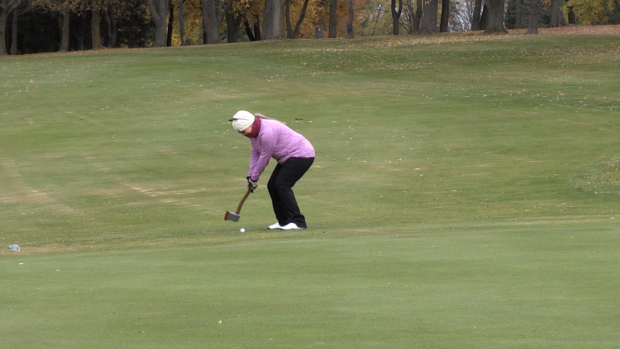 Golfer using an axe as a golf club at Scary-Hill 2024. Oct. 27, 2024 (Colton Wiens/CTV News)