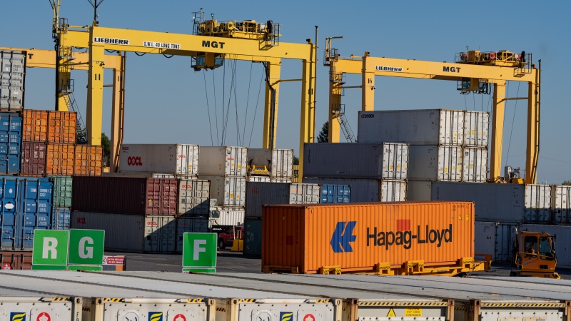 Shipping containers are moved in the Port of Montreal, Monday, Sept. 30, 2024. Port of Montreal longshore workers have started a three-day strike at two terminals. (Christinne Muschi / The Canadian Press)