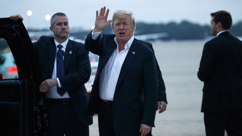 U.S. President Donald Trump yells to reporters after arriving at Andrews Air Force Base after a summit with North Korean leader Kim Jong Un in Singapore, June 13, 2018 (AP Photo/Evan Vucci)