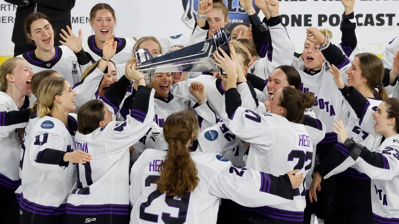 Minnesota players celebrate with the Walter Cup after defeating Boston to win the PWHL Walter Cup, May 29, 2024, in Lowell, Mass. (AP Photo/Mary Schwalm, File)