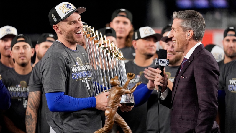 Los Angeles Dodgers' Freddie Freeman celebrates with the trophy after their win against the New York Yankees in Game 5 to win the baseball World Series, Thursday, Oct. 31, 2024, in New York. (AP Photo/Ashley Landis)