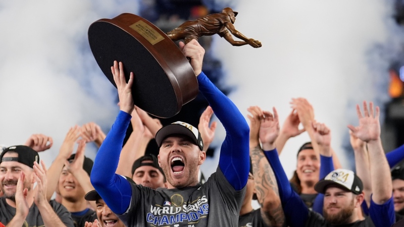 Los Angeles Dodgers' Freddie Freeman celebrates with the MVP trophy after their win against the New York Yankees in Game 5 to win the baseball World Series, Oct. 31, 2024, in New York. (AP Photo/Ashley Landis)