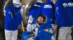 In this photo released by Xinhua News Agency, astronaut Li Guangsu waves as he is carried out of the re-entry capsule of the Shenzhou-18 manned space mission after it landed successfully at the Dongfeng landing site in northern China's Inner Mongolia Autonomous Region, Nov. 4, 2024. (Li Xin/Xinhua via AP)