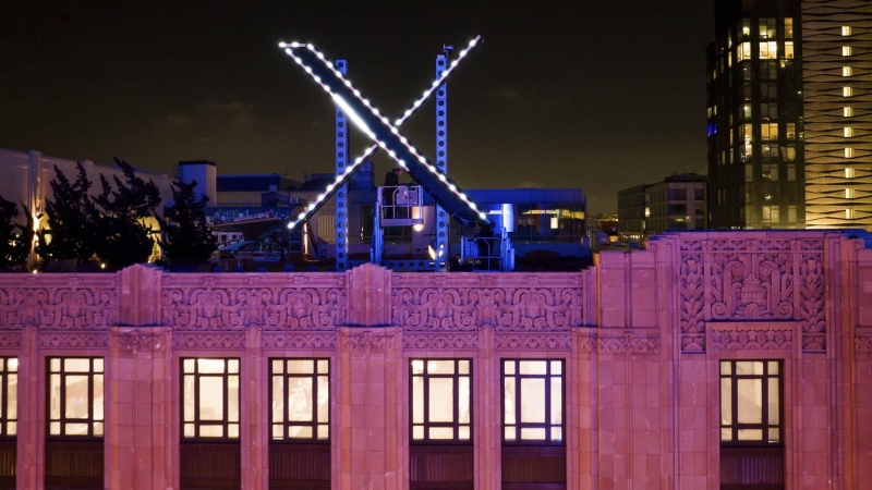 Workers install lighting on an "X" sign atop the company headquarters, formerly known as Twitter, in downtown San Francisco, July 28, 2023. (AP Photo/Noah Berger, File)
