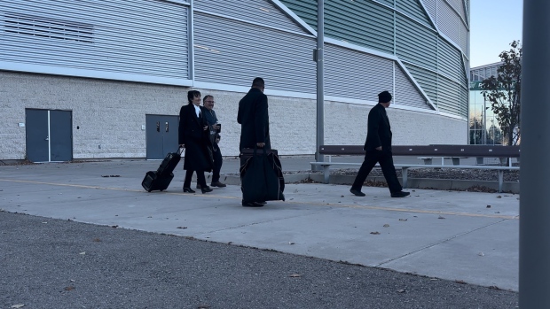 Ruben Manz (right) and his legal team exiting a makeshift court room at Mosaic Stadium on Monday, Nov. 4, 2024. (Hallee Mandryk/CTV News)