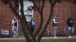 Voters stand in line while waiting for a polling place to open, Tuesday, Nov. 5, 2024, in Springfield, Pa. (AP Photo/Matt Slocum)