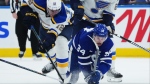 St. Louis Blues forward Radek Faksa (12) and Toronto Maple Leafs forward Auston Matthews (34) battle for the puck during NHL action in Toronto on Thursday, Oct. 24, 2024. Maple Leafs captain Matthews will miss Tuesday's game against the Boston Bruins with an upper-body injury. THE CANADIAN PRESS/Nathan Denette