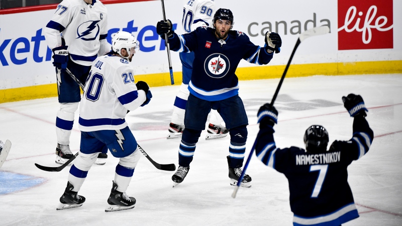 Winnipeg Jets left wing Alex Iafallo (9) celebrates his goal against the Tampa Bay Lightning with teammate Vladislav Namestnikov (7) during third period NHL hockey action in Winnipeg on Sunday November 3, 2024. (Fred Greenslade/The Canadian Press)