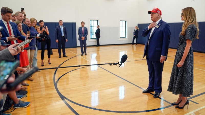 Republican presidential nominee Donald Trump speaks as former first lady Melania Trump listens after they voted at the Morton and Barbara Mandel Recreation Center in Palm Beach, Fla., on  Nov. 5, 2024. (Evan Vucci / AP Photo)