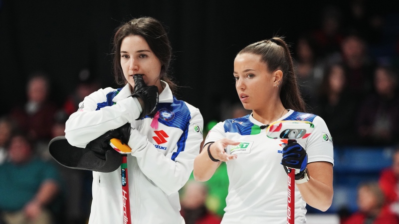 Italy's Stefania Constantini, left, and Giulia Zardini Lacedelli discuss shot options during World Women’s Curling Championship action against Sweden in Sydney, N.S. on Sunday, March 17, 2024. (Darren Calabrese/The Canadian Press)