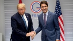 U.S President Donald Trump, left, and Prime Minister Justin Trudeau take their seats as they participate in a bilateral meeting at the G-7 summit in Biarritz, France on Aug. 25, 2019 (AP Photo/Andrew Harnik)