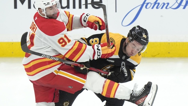 Calgary Flames centre Nazem Kadri and Boston Bruins centre Tyler Johnson collide during the third period in Boston on Nov. 7, 2024. (AP Photo/Steven Senne)