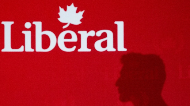 Justin Trudeau's shadow is cast against a wall displaying the Liberal Party of Canada's logo during a fundraiser in Ottawa on  June 10, 2024. (Spencer Colby / The Canadian Press)