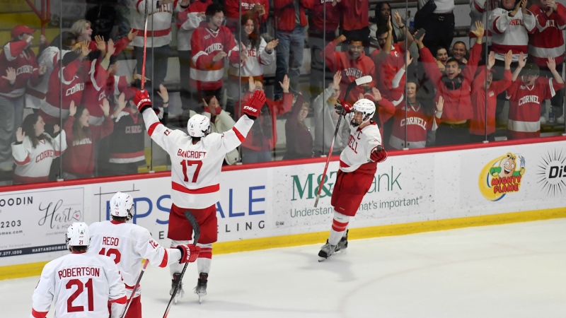 Cornell forward Kyle Penney, right, celebrates with forward Dalton Bancroft (17) after scoring during the third period of an NCAA hockey game against North Dakota on Nov. 2, 2024 in Ithaca, N.Y. (AP Photo/Adrian Kraus, file)