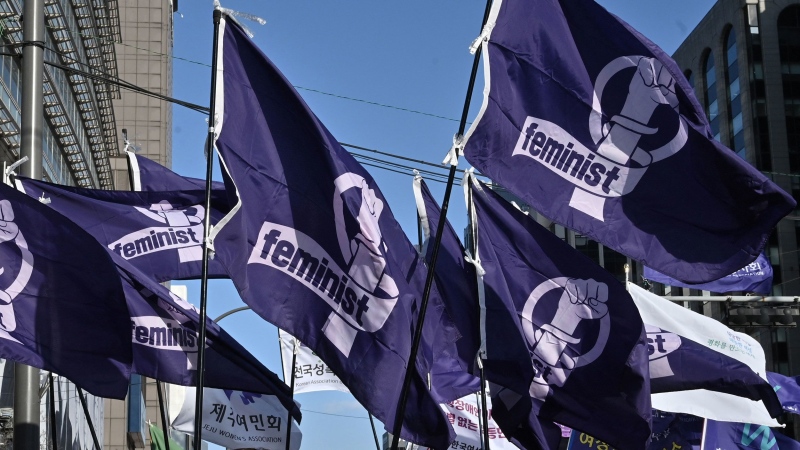 South Korean women carry flags reading "feminist" during a rally in Seoul earlier this year to mark International Women's Day. (Jung Yeon-Je/AFP/Getty Images via CNN Newsource)