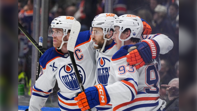 Edmonton Oilers' Connor McDavid, from left to right, Leon Draisaitl and Ryan Nugent-Hopkins celebrate Draisaitl's goal against the Vancouver Canucks during the first period of an NHL hockey game in Vancouver, on Saturday, November 9, 2024. THE CANADIAN PRESS/Darryl Dyck