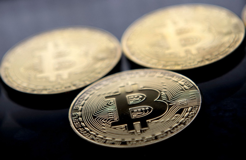 Gold-plated souvenir Bitcoin coins are arranged for a photograph in London in November 2017. (Justin Tallis/AFP/Getty Images via CNN Newsource)