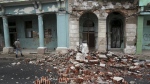 Debris from a building damaged by the passage of Hurricane Rafael covers the street in Havana, Cuba, Thursday, Nov. 7, 2024. (AP Photo/Ariel Ley)