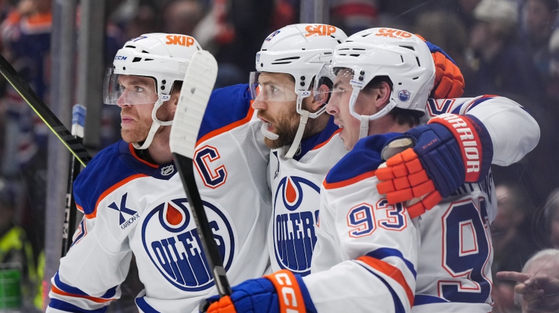 Edmonton Oilers' Connor McDavid, from left to right, Leon Draisaitl and Ryan Nugent-Hopkins celebrate Draisaitl's goal against the Vancouver Canucks during the first period of an NHL hockey game in Vancouver, on Saturday, November 9, 2024. (Darryl Dyck / The Canadian Press) 