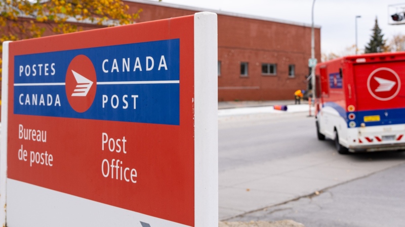 A Canada Post delivery truck leaves its depot in Montreal, Nov. 4, 2024. THE CANADIAN PRESS/Christinne Muschi