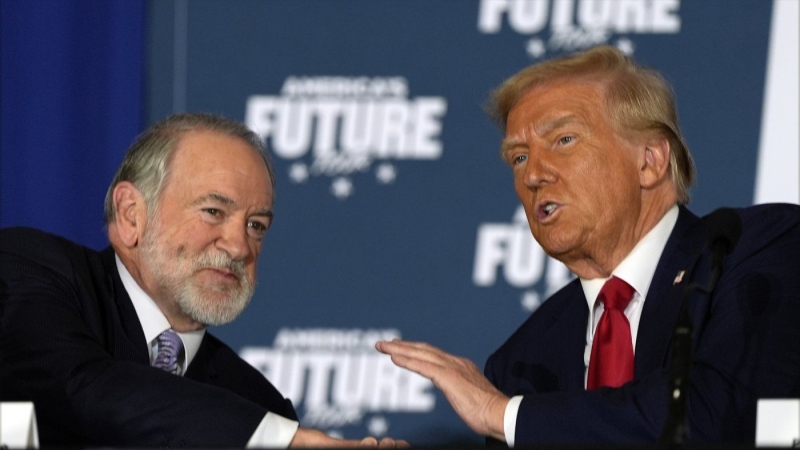 Republican presidential nominee former President Donald Trump talks with former Arkansas Gov. Mike Huckabee during a roundtable at the Drexelbrook Catering & Event Center, Tuesday, Oct. 29, 2024, in Drexel Hill, Pa. (AP Photo/Julia Demaree Nikhinson)