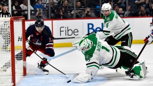 Dallas Stars goaltender Casey DeSmith (1) makes a save on Winnipeg Jets' Adam Lowry (17) during second period NHL hockey action in Winnipeg on Saturday November 9, 2024. (Fred Greenslade/The Canadian Press)