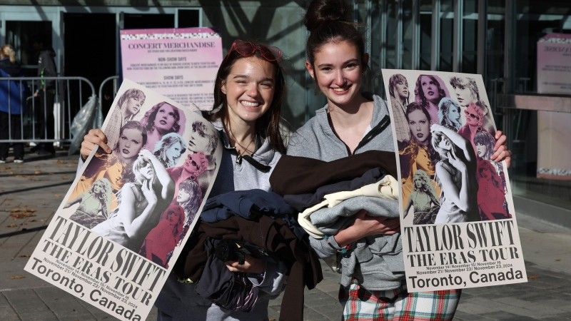 Taylor Swift fans Catherine York (left) and Emma Quinn (right) are pictured after purchasing Taylor Swift Eras Tour merchandise outside the Rogers Centre, in Toronto, on November 12, 2024. (Richard Lautens/Toronto Star via Getty Images)