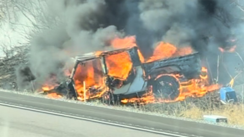 A pickup truck on fire after hitting a tree on Highway 401 near Kingston, Ont. on Wednesday, Nov. 13, 2024. (Ontario Provincial Police) 