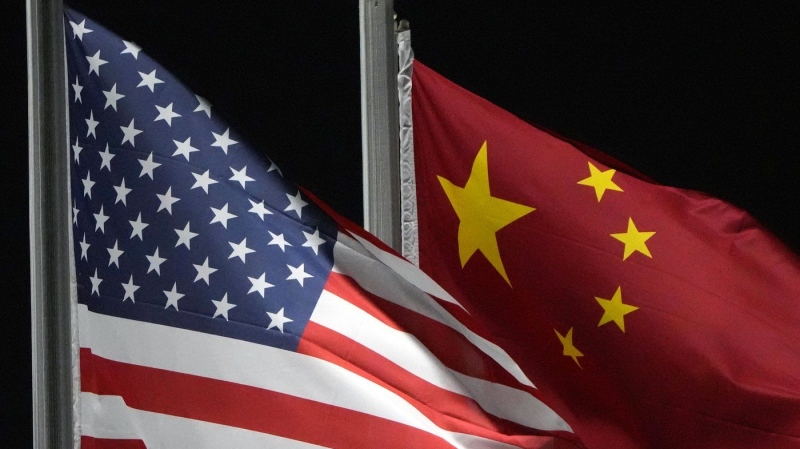 The American and Chinese flags wave at Genting Snow Park, Feb. 2, 2022, in Zhangjiakou, China. (AP Photo/Kiichiro Sato, File)